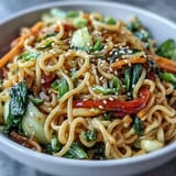 Freshly prepared Shirataki Noodle Bowl garnished with toasted sesame seeds and cilantro, served steaming hot in a ceramic bowl.