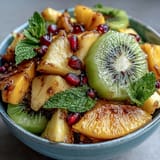 Vibrant tropical fruit platter with mango and pineapple slices, perfect for summer parties and brunches.  