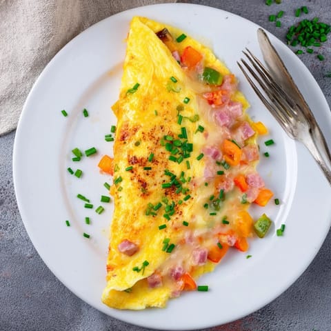 Perfectly folded, this classic French omelet features melted cheese inside a tender egg blanket. 