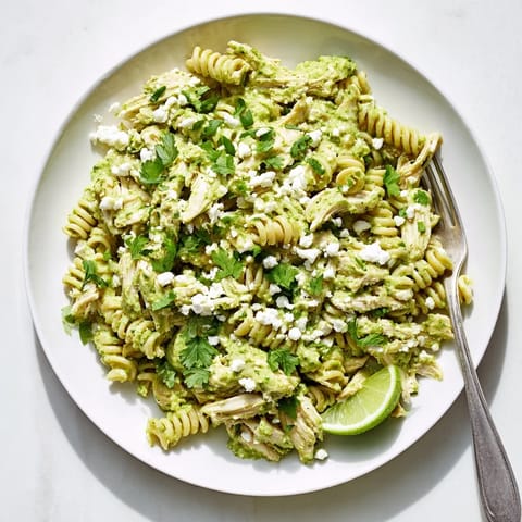 Creamy cilantro lime chicken pasta garnished with crumbled cotija cheese and extra chopped cilantro.