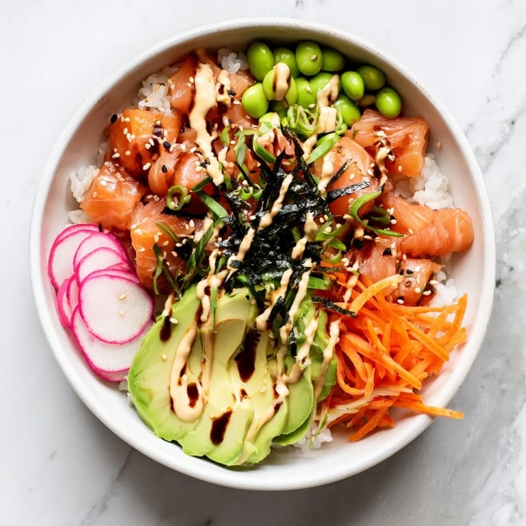 Colorful homemade poke bowl arranged with sushi-grade fish, radishes, nori strips, and lime wedges on a bed of fluffy rice.