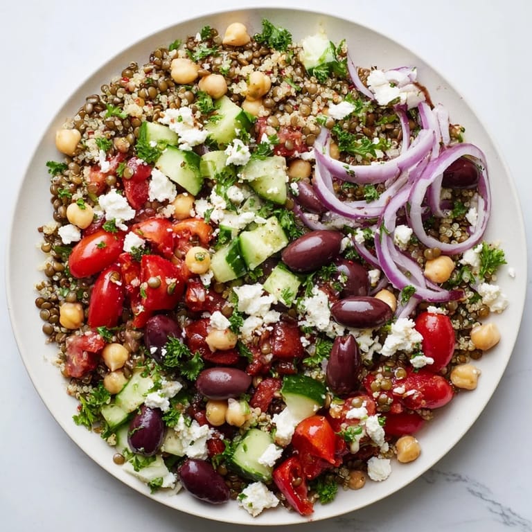 Freshly tossed Greek Power Salad served as a light dinner, topped with crumbled feta cheese and chopped parsley for a nutritious meal.