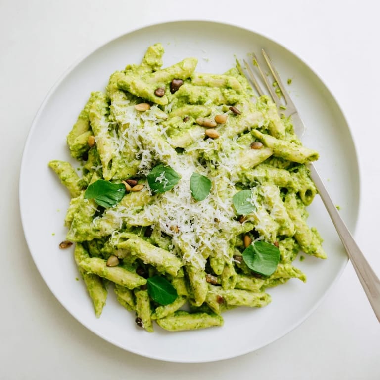 Savory Creamy Sunflower Seed Pesto Pasta served warm, garnished with lemon zest for a bright finish.
